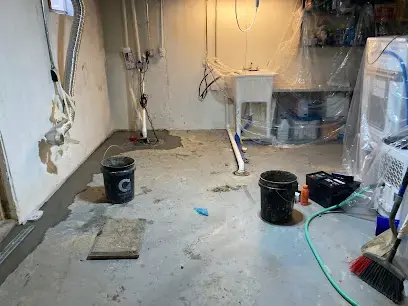 Basement laundry area opened up and drying after a floor drain backup