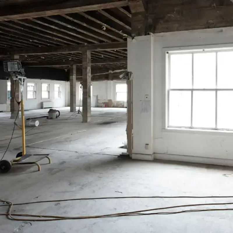 Gutted space with the walls opened and the floor drying after water damage